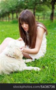 Girl play with golden retriever in park