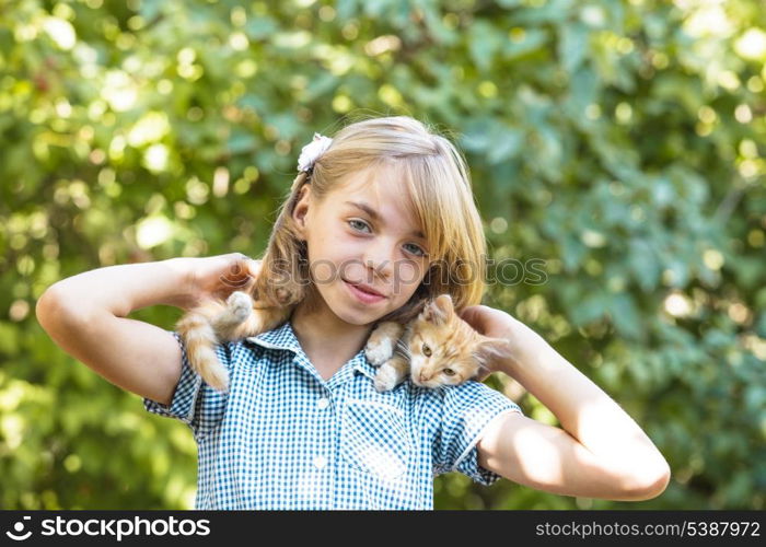 Girl play with kitten outdoor in the park