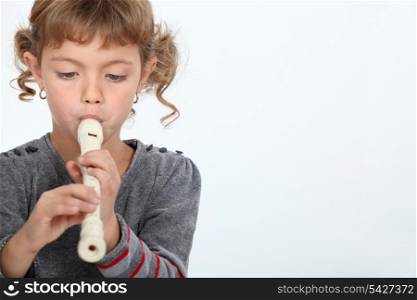 Girl playing a recorder