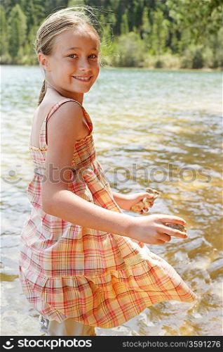 Girl Playing by Lake