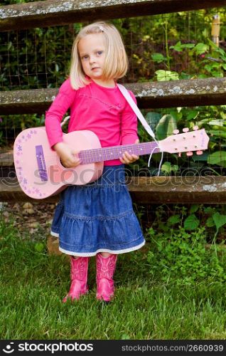 Girl playing guitar, portrait