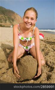 Girl Playing in Sand at Beach