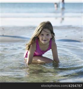 Girl playing in water on beach