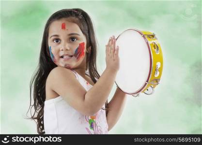 Girl playing on a tambourine