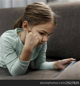 girl playing smartphone home