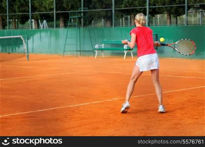 Girl playing tennis outdoor on court
