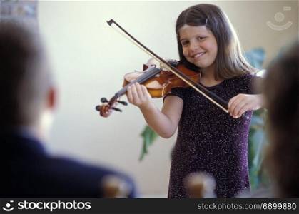 Girl Playing Violin For Parents