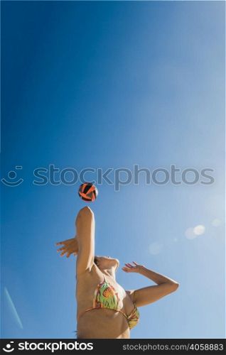 girl playing volleyball sunny day