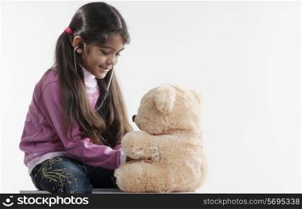 Girl playing with a teddy bear
