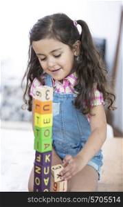 Girl playing with blocks at home