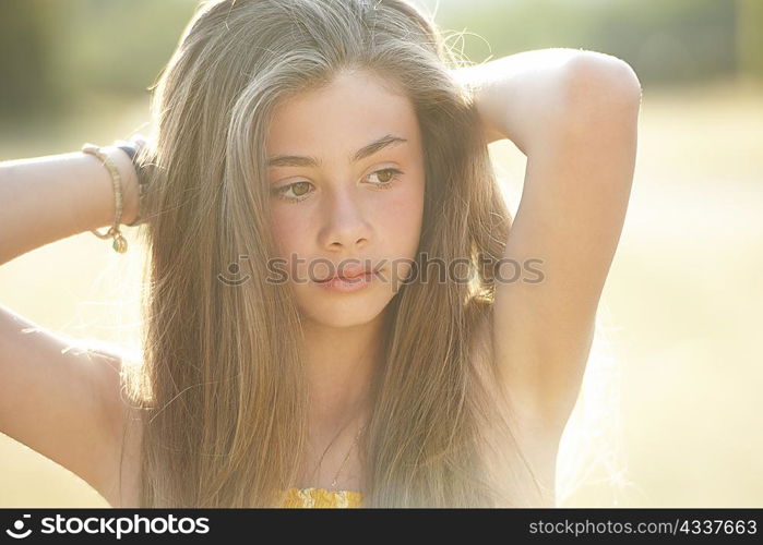 Girl playing with hair outdoors