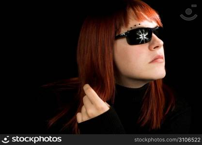 Girl playing with her hair. With sunglasses. Lit with three studio strobes.
