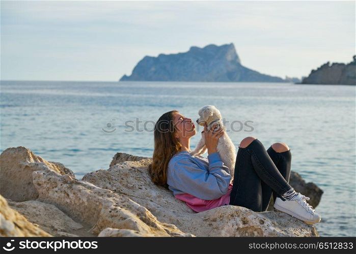 Girl playing with maltichon dog in the beach. Girl playing with maltichon puppy dog in the beach