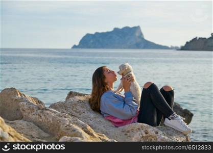 Girl playing with maltichon dog in the beach. Girl playing with maltichon puppy dog in the beach