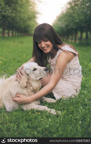 Girl plays with golden retriever in the park. Girl plays with dog
