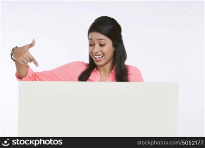 Girl pointing at white board