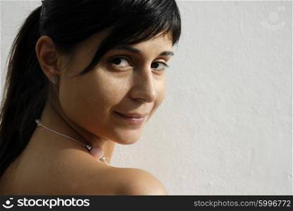 girl portrait with a smile in a white wall