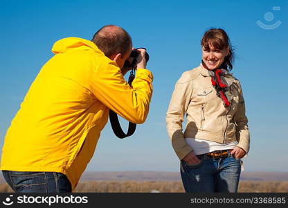 Girl poses for photographer, photosession on nature. Hobby which unites people.