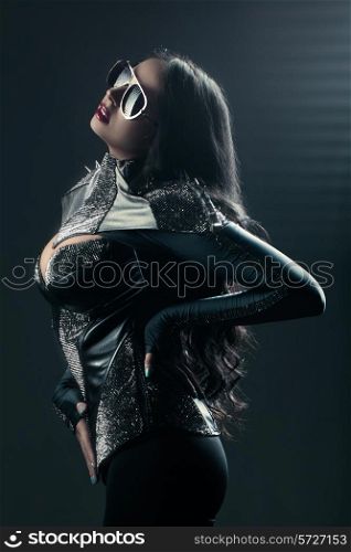girl posing in black jacket with spikes and sunglasses