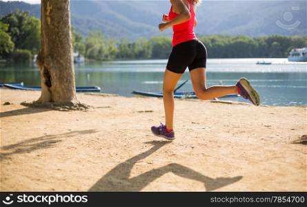Girl practicing athletics beside a lake