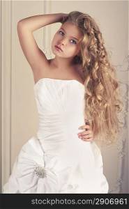 Girl princess in white ball gown in classic interior