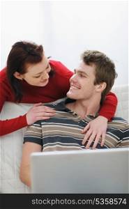 Girl pulling attention of boyfriend from laptop to herself