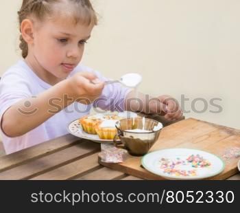 Girl puts focus on confectionery glaze Easter cupcakes