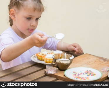 Girl puts focus on confectionery glaze Easter cupcakes