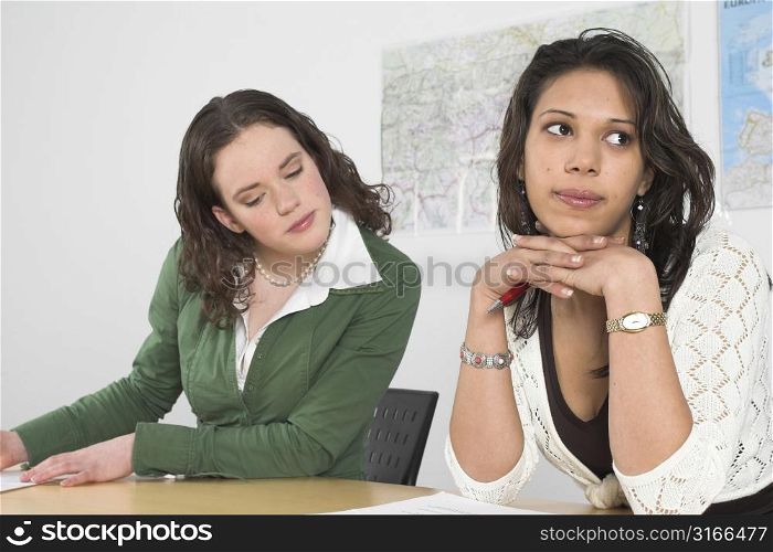 Girl quickly taking a glance at the paper of her co-student