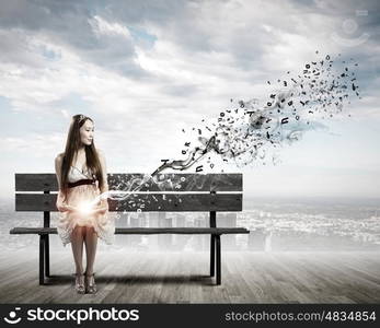 Girl reading book. Asian pretty woman sitting on bench and reading book