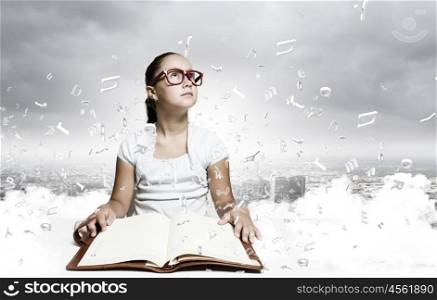 Girl reading book. School pretty girl in red glasses reading book