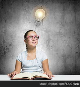 Girl reading book. School pretty girl in red glasses reading book