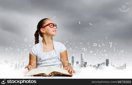 Girl reading book. School pretty girl in red glasses reading book