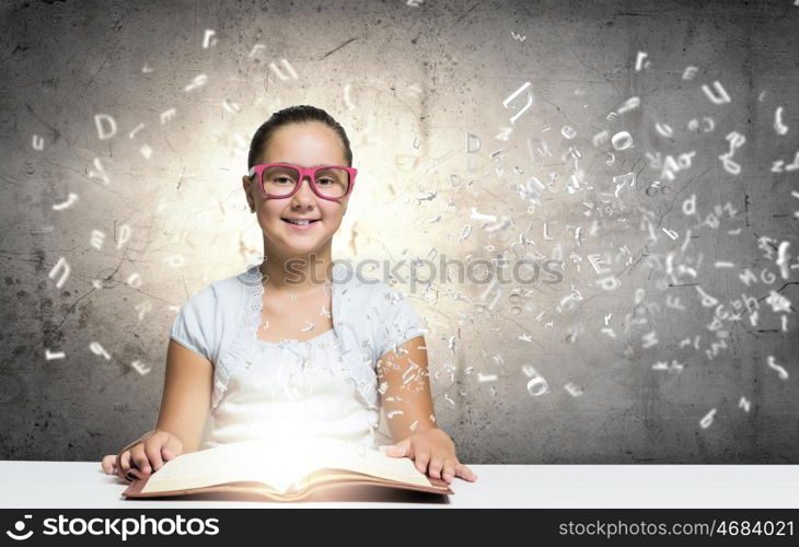 Girl reading book. School pretty girl in red glasses reading book