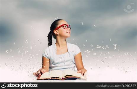 Girl reading book. School pretty girl in red glasses reading book