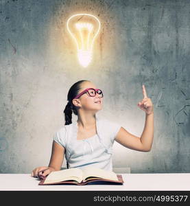 Girl reading book. School pretty girl in red glasses reading book