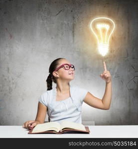 Girl reading book. School pretty girl in red glasses reading book