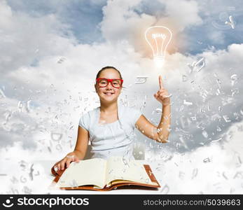 Girl reading book. School pretty girl in red glasses reading book