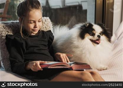girl reading dog listening