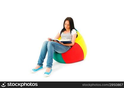 Girl reading the book on white