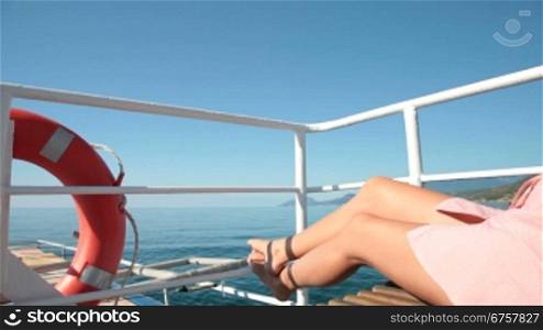 Girl relaxing on the deck of the yacht