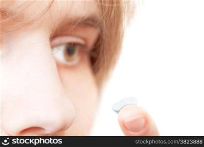girl removes contact lens from eye close up