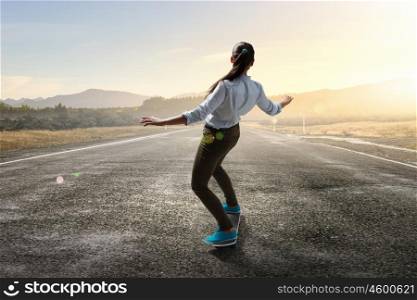 Girl ride skateboard. Active girl riding skateboard on asphalt road