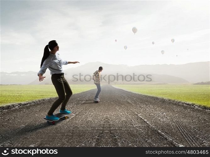 Girl ride skateboard. Active girl riding skateboard on countryside road
