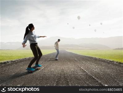Girl ride skateboard. Active girl riding skateboard on countryside road