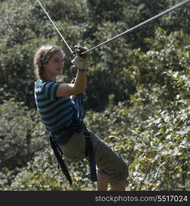 Girl riding a zip line in a forest, Copan, Copan Ruinas, Copan Department, Honduras