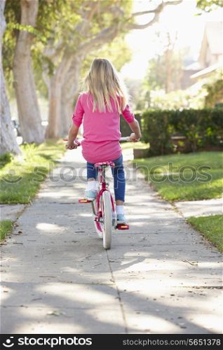Girl Riding Bike Along Path