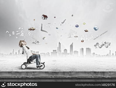 Girl riding bike. Little cute girl of preschool age riding tricycle