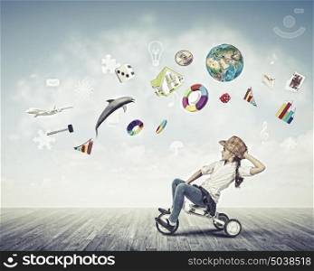Girl riding bike. Little cute girl of preschool age riding tricycle. Elements of this image are furnished by NASA