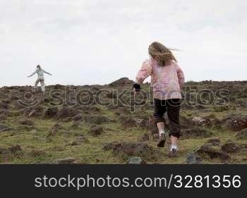 Girl running in field in Kenya